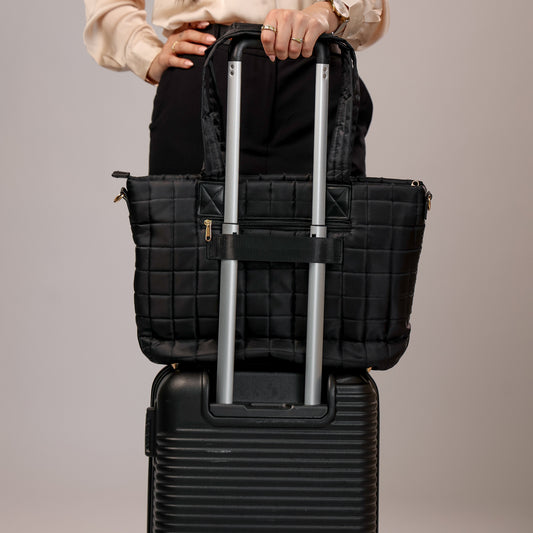 Woman carrying the Athena Nyx nylon tote on her shoulder